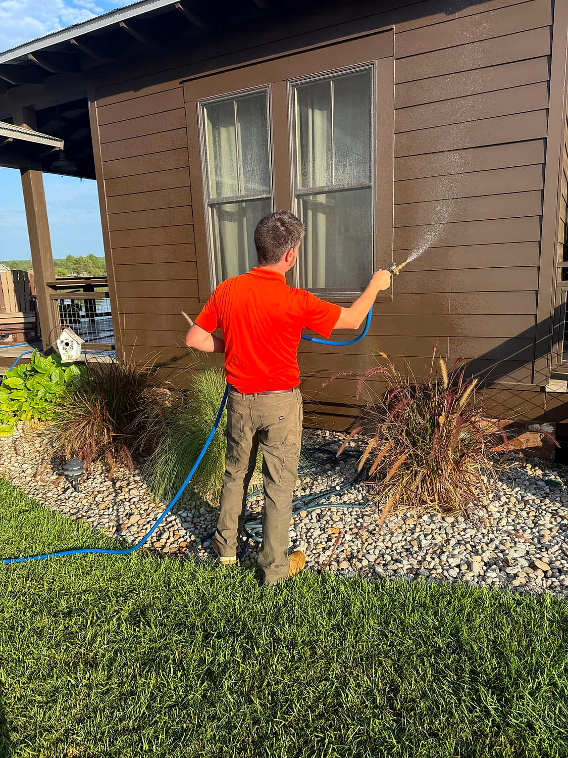 A Parker's Pest Management technician treating the outside of a home