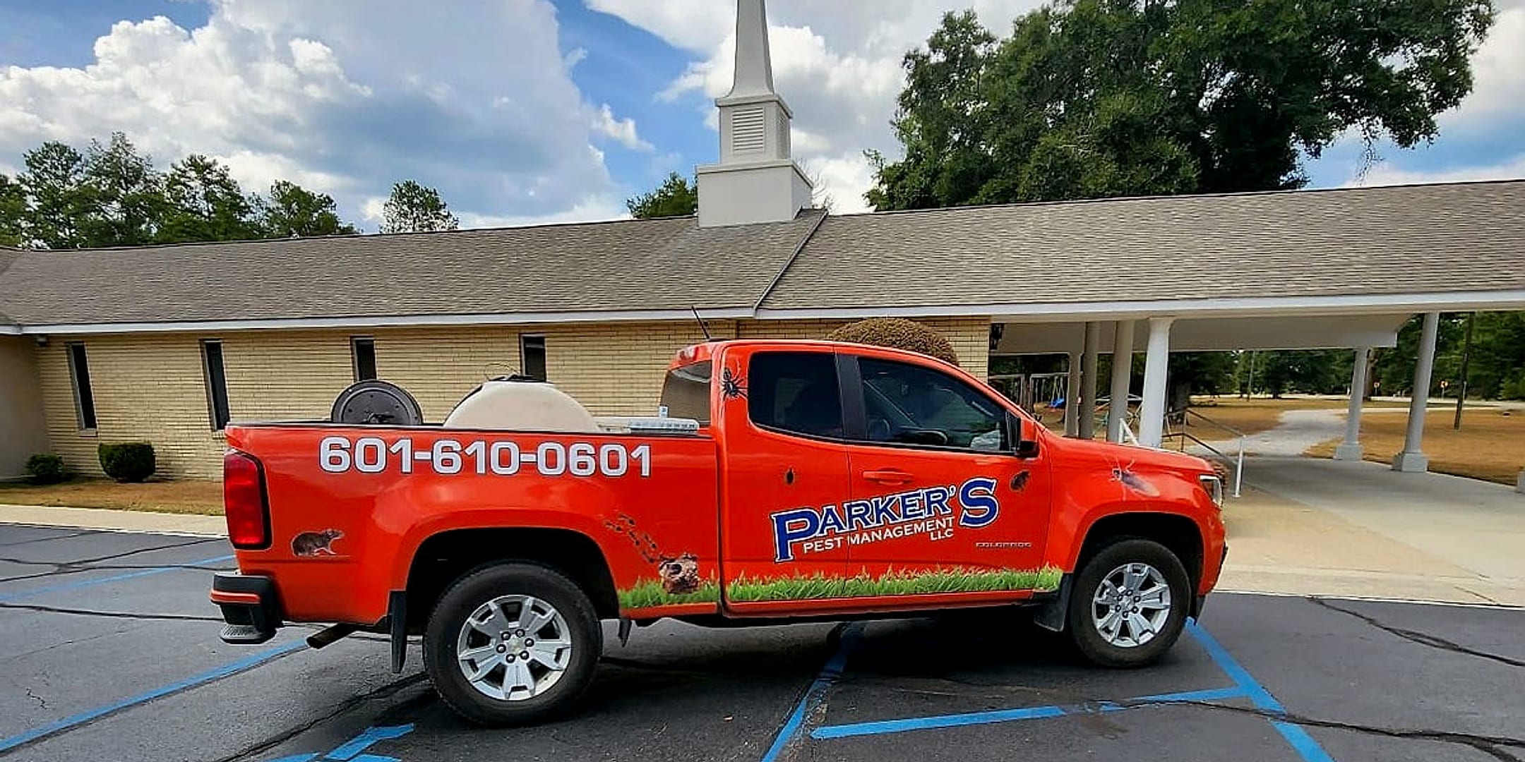 A Parker's Pest Management truck parked at a church