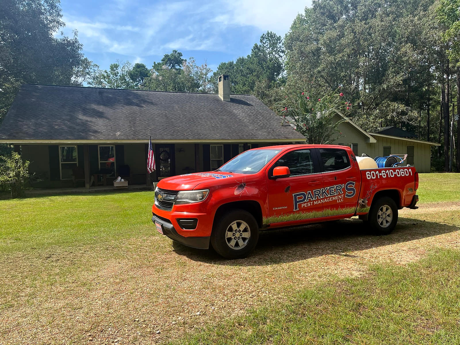 A Parker's Pest Management truck parked at a home in the Pine Belt